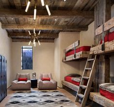 a room with bunk beds, couches and ladders in the middle of it