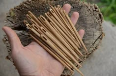 a person holding several wooden sticks in their hand