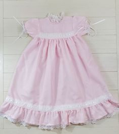 Every little southern belle needs this dress in their closet. Cotton Smock Dress In Cottagecore Style, Pastoral Cotton Dresses With Ruffles, Cottagecore Victorian Cotton Dress With Ruffles, Vintage Cotton Dress With Smocked Bodice, Pastoral Cotton Dresses With Lace Trim, Classic Pink Cotton Dress, Pink Cotton Vintage Dress With Lace Trim, Heirloom Dresses, White Romper