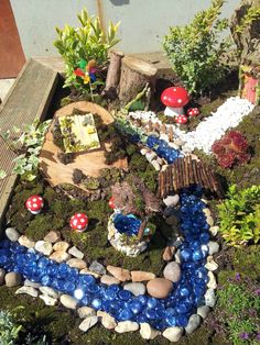 a miniature garden with rocks and plants in the shape of a toad's house