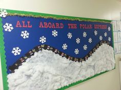 a bulletin board with snow on the bottom and an all aboard the polar express sign above it