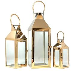 three gold colored lanterns with one light on each side and the other in different sizes