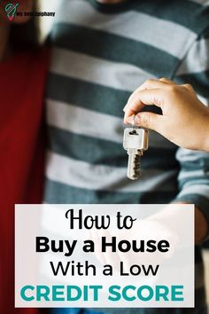 a man holding a house key with the words how to buy a house with a low credit score