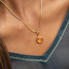 Bring harmony to your everyday look with this orange agate touchstone necklace. Designed with an open sunrise back to allow the stone to sit close to you when worn, this necklace looks stunning from all angles. Shimmering with deep orange hues the orange agate healing stone hangs beautifully from our slim snake chain and inspires emotional balance, clarity and harmony.  All our charms attach with a clip-on clasp and are compatible with all other leading charm jewellery brands. Simply clip-on or slide-on to a chain, charm bracelet or charm carrier necklace.  All Lily Charmed jewellery comes presented in a beautiful gift box hand tied with ribbon. Material: 18ct Gold Plated Recycled Sterling Silver with Orange Agate.  At Lily Charmed, we strive to provide our customers with the highest quali Gemstone Round Pendant Necklace, Gemstone Round Pendant Necklace For Meditation, Orange Gemstone Jewelry With Round Pendant, Handmade Orange Necklace For Everyday, Orange Gemstone Oval Pendant Necklace, Amber Oval Pendant Necklace, Amber Crystal Necklace For Gift, Orange Agate Gemstone Necklace, Everyday Spiritual Orange Jewelry