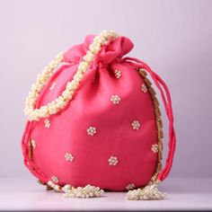 Material:Organza, PearlColor: Carat PinkPackage Contents: As per quantity purchasedSize: 22 cm x 22 cm x 5 cmDesigned with the heart, this beautiful Potli or batawa bag are eye catchy and made of premium material.Key Features:Embroidery art workThis potli is good match with both Indian and western outfits and are superb for wedding and festive partiesThis would be best complement to your designer saree, lenhga or any other kind of dressThis is the combination of traditional and modern embroidery Pink Shoulder Bag With Handwork For Party, Elegant Pink Shoulder Bag For Festivals, Pink Handwork Pouch Bag, Traditional Evening Gift Bag, Pink Bag For Festive Party, Pink Bags For Evening And Festivals, Elegant Pink Shoulder Bag For Festive Occasions, Festive Pink Bag For Party, Festive Gift Pouch Bag