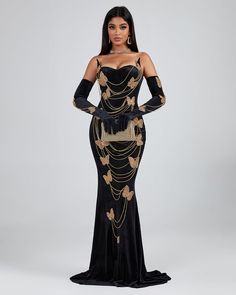 a woman in a black and gold evening gown