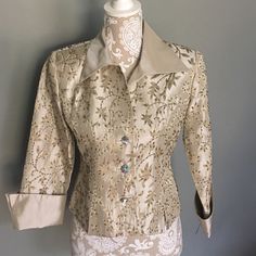 This Button-Up Is Tan-Ish And Stylish. It Has An Embroidered Floral-Like Design That's Beaded For Extra Pizzazz. Price Is Open For Negotiation. Classic Beige Top For Party, Elegant Tops With Gold Buttons, Formal Fitted Tops With Pearl Buttons, Elegant Tops With Snap Buttons For Formal Occasions, Elegant Embellished Beige Tops, Elegant Formal Tops With Snap Buttons, Elegant Beige Embellished Tops, Elegant Gold Top With Button Closure, Elegant Embroidered Beige Tops