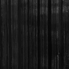 an abstract black and white photo with vertical lines in the background that appear to be painted on wood