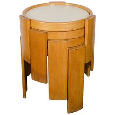 a small wooden table with three drawers on one side and two smaller ones on the other