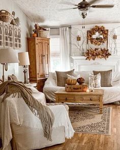 a living room filled with lots of furniture and decor on top of wooden flooring