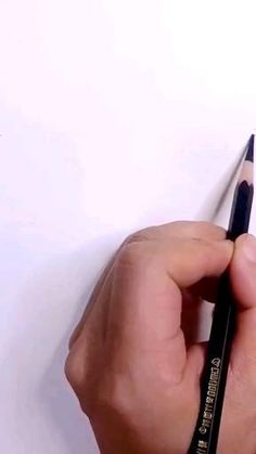 a person holding a pencil in their left hand