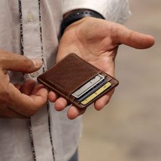 HAND-STAINED BUFFALO LEATHER When a few cards and a photo ID are all that you really need to carry, this slim leather wallet is the perfect companion. Made from hand stained buffalo leather that grows in character and beauty as it ages, this small Voyager Wallet features rounded corners to resist breakage, RFID protection, and three card slots to hold your credit card, bank card, and a membership card. The ID window is perfect for your driver's license, school, or work ID. This hand made leather Blue Leather Wallet, Slim Wallet Men, Bifold Wallet Men, Minimalist Leather Wallet, Wallets For Men, Leather Ideas, Slim Leather Wallet, Leather Passport Holder, Leather Card Wallet