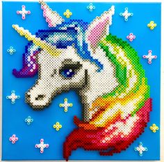 an image of a cross stitch unicorn on a blue background