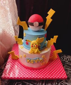 a pokemon themed birthday cake with pikachu on top