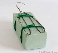 a pair of earrings with green cords attached to them