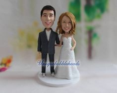 a wedding cake topper with a bride and groom