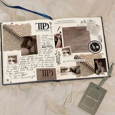 an open scrapbook with pictures and writing on the pages, along with a blue ribbon