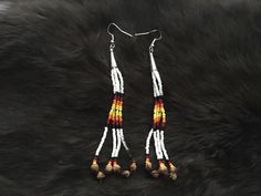 Authentic Beautiful Native American Indian Jewelry Navajo Hand Beaded Long Dangle Earrings with "Ghost Beads" Great for a gift❤️ Handcrafted by Navajo Artist R. Sellers These beautiful earrings are approximately 4.5" in length and 1" in width. Ghost Beads Represent interconnection with the earth, trees, animals and humans. Wear it to bring about peace, harmony and safety. It wards off negative energy, bringing about protection from evil spirits, ghosts and nightmares. Give them as gifts or buy for yourself! Southwestern Dangling Beads For Jewelry Making, White Round Bead Southwestern Earrings, Southwestern Adjustable Dangling Bead Earrings, Southwestern Style Earrings With Dangling Round Beads, Southwestern Style Earrings With Round Beads For Festivals, Southwestern Style Round Bead Earrings For Festivals, Southwestern Dangle Beaded Earrings, Traditional Jewelry Beaded Fringe For Jewelry Making, Southwestern Style White Earrings For Festivals