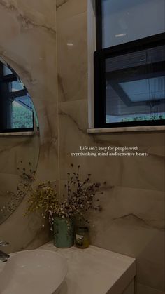 a bathroom with a sink, mirror and window in the wall next to each other