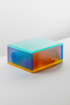 a multicolored box sitting on top of a white table