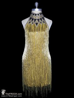 "BIG NEWS After 22 years, our website, TheFROCK.com, has had a makeover. Check out the new site, and join our mailing list for new arrivals.  Vintage Bob Mackie gold beaded fringe (on silk georgette) halter dress with contrast beaded halter neck, and nearly open back. Rear zipper entry. Condition is excellent with only an occasional discreet mark or discolor hidden on the interior. The dress would fit a variety of bust measurement as it has a largely open back, dress dress measures about 33.5\" Glamorous Gold Halter Dress For Party, Gatsby Style Flapper Dress For Gala Party Season, Gold Summer Evening Dress For Gala, Gold Halter Dress For Party, Elegant Gold Sleeveless Halter Dress, Gold Gatsby Style Flapper Dress, Gold Halter Neck Cocktail Dress, Sleeveless Flapper Dress For Gala And Party Season, Gala Evening Dress With Beaded Fringe For Party Season