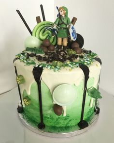 a green and white decorated cake on top of a table