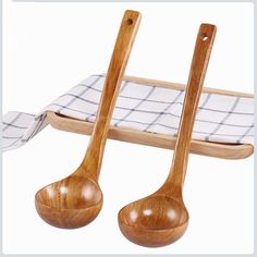 two wooden spoons sitting next to each other