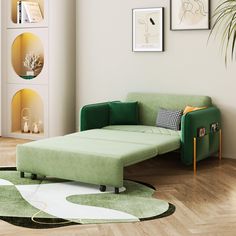 a green couch sitting on top of a hard wood floor next to a white wall