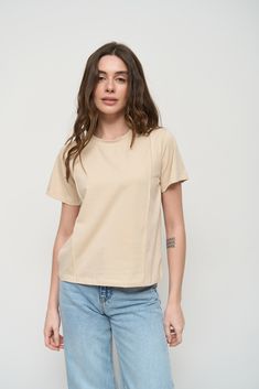 The basic cotton T-Shirt is a must-have for every wardrobe. The main thing of this model is accent seams that visually stretch the silhouette and make your outfit more interesting. It is suitable for various occasions such as taking a walk with your child, as well as meetings with friends or going on vacation. Pair a T-Shirt with straight or wide-leg jeans and sneakers for a comfortable casual look. Beige T Shirt, Make Your Outfit, Beige T Shirts, Taking A Walk, Top Pants Set, Sweater Tank Top, Women's T Shirts, Sweater And Shorts, On Vacation