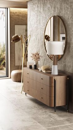 a living room with a large mirror on the wall next to a dresser and lamp