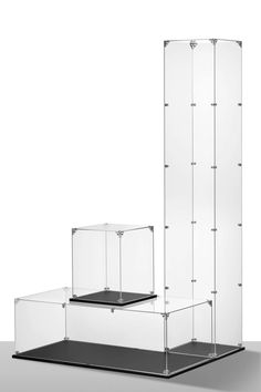 three glass cases sitting next to each other