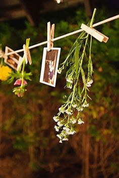 flowers hanging from clothes line with pictures on them