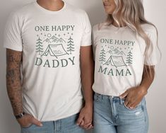 a man and woman standing next to each other wearing shirts that say one happy daddy and one happy mama