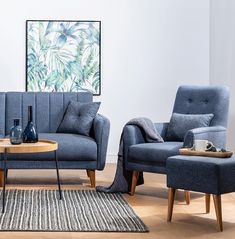 a living room with two blue couches and a coffee table in front of it