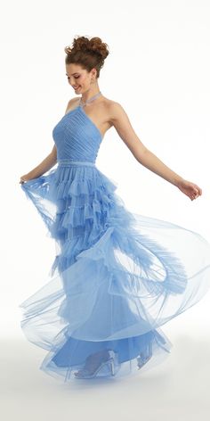 a woman in a blue dress is dancing