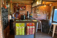 the inside of a small restaurant with brick walls and counter tops, along with various types of snacks