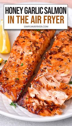 cooked honey garlic salmon fillets on white plate with text overlay "honey garlic salmon in the air fryer". Easter Entrees, Salmon Recipes Baked Healthy, Air Fryer Salmon, Honey Garlic Salmon, Garlic Salmon