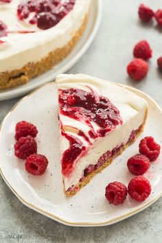 a slice of cheesecake with raspberry topping on a plate next to the rest of the pie