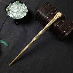 a wooden stick sitting on top of a table next to a bowl of ice