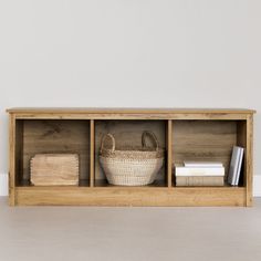 a wooden shelf with baskets and books on it