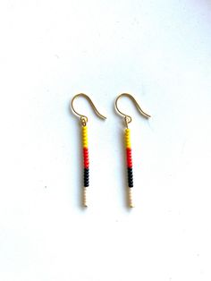 These minimalist drop earrings are made with thick gold plated wire and glass beads colored to represent the Native American Four Directions and Medicine Wheel. Although different tribes interpret the Medicine Wheel differently in terms of direction and color association, generally each of the Four Directions (west, north, east and south) are typically represented by a distinctive color: black, red, yellow, and white. North is red, East is yellow, South is white and West is Black. The Four Direc Minimalist Beaded Drop Earrings, Minimalist Wire Wrapped Beaded Earrings For Gift, Minimalist Beaded Dangle Earrings, Minimalist Everyday Dangle Beaded Earrings, Minimalist Adjustable Wire Wrapped Beaded Earrings, Minimalist Gold Beaded Earrings With Ear Wire, The Four Directions, Beaded Eye, Fringe Jewelry