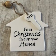 a ceramic ornament that says first christmas in our new home