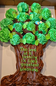 cupcakes in the shape of a tree with green frosting on top and words written below