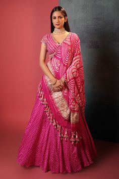 Pink attached can-can silk lehenga with all over bandhani pattern. Paired with a padded floral gota embroidered blouse and bandhani dupatta, highlighted with gota and cutdana.
Components: 3
Pattern: Woven, Embroidery
Type Of Work: Bandhani, Gota
Neckline: V Neck
Sleeve Type: Short Sleeves
Fabric: Silk
Color: Pink
Other Details: 
Lehenga:
Attached can-can
Gota embroidered broad waistband
Length: 42 inches
Blouse:
Padded
Back tie-up detailing
Length: 14 inches
Dupatta:
Beaded and tassel work borde Bandhani Pattern, Orang India, Long Blouse Designs, Bandhani Dress, Lehenga Designs Simple, Indian Bride Outfits, Anarkali Dress Pattern, Gaun Fashion, Indian Dresses Traditional