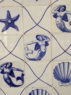 blue and white tiles with mermaids, shells and starfish