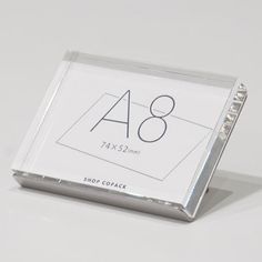 a clear acrylic sign with the number eight on it's front side