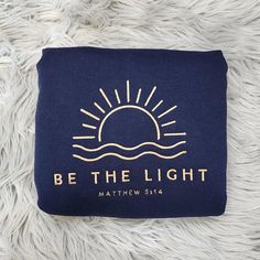 Shine your light for all to see with this Be The Light Embroidered Crewneck featuring the inspiring verse from Matthew 5:14. This cozy, faith-filled sweatshirt serves as a reminder to reflect God's light in the world and live out His purpose. Whether you're heading to church, a Bible study, or simply sharing your faith in everyday life, this crewneck offers both comfort and inspiration, rooted in Scripture. Customize this design by choosing thread color.  Choose from a variety of styles to suit any season and preference, including t-shirts for warmer days, long sleeve t-shirts for cooler weather, and crewneck sweatshirts or hoodies for those chilly evenings. Unisex sizing is great fit for both men and women. 💎 What sets our garments apart? The intricate embroidery! Here's why embroidered Embroidery Christian, God's Light, Christian Embroidery, Christian Clothes, Divine Purpose, Christian Crewneck, Add Sleeves, Be The Light, Shine Your Light