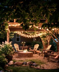 an outdoor fire pit surrounded by chairs and lights