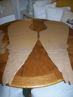 a wooden table with angel wings cut out of it