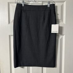 Nwt Calvin Klein Pencil Skirt. Charcoal Gray In Color. Zipper With Hook And Eye Back Closure. Fully Lined. Polyester/Rayon/Spandex Material. Size 2. Chic Calvin Klein Skirt For Workwear, Chic Calvin Klein Skirt For Work, Elegant Calvin Klein Skirt For Work, Calvin Klein Fitted Pencil Skirt, Calvin Klein Fitted Skirt, Fitted Calvin Klein Casual Skirt, Calvin Klein Fitted Casual Skirt, Casual Fitted Calvin Klein Skirt, Womens Calvin Klein